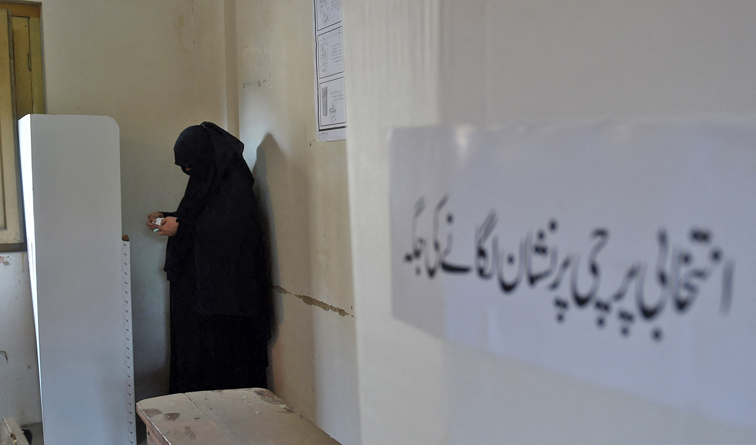 A Pakistani woman casts her ballot at a polling station in Karachi on December 5, 2015, during local government elections. (AFP/File)
