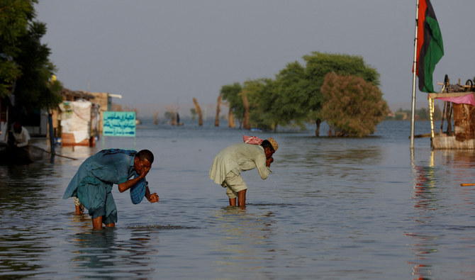 Men perform ablution with the flood water, following rains and floods during the monsoon season in Bajara village, at the banks of Manchar lake, in Sehwan, Pakistan September 6, 2022. (REUTERS/FILE)