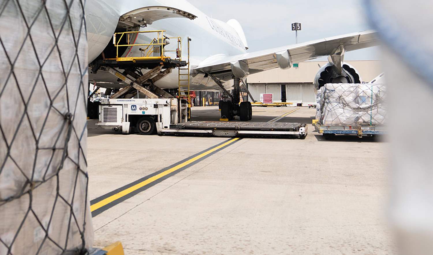 This undated file photograph shows Air Menzies International (AMI) equipments unloading cargo from an aircraft. (Photo courtesy: airmenzies.com)