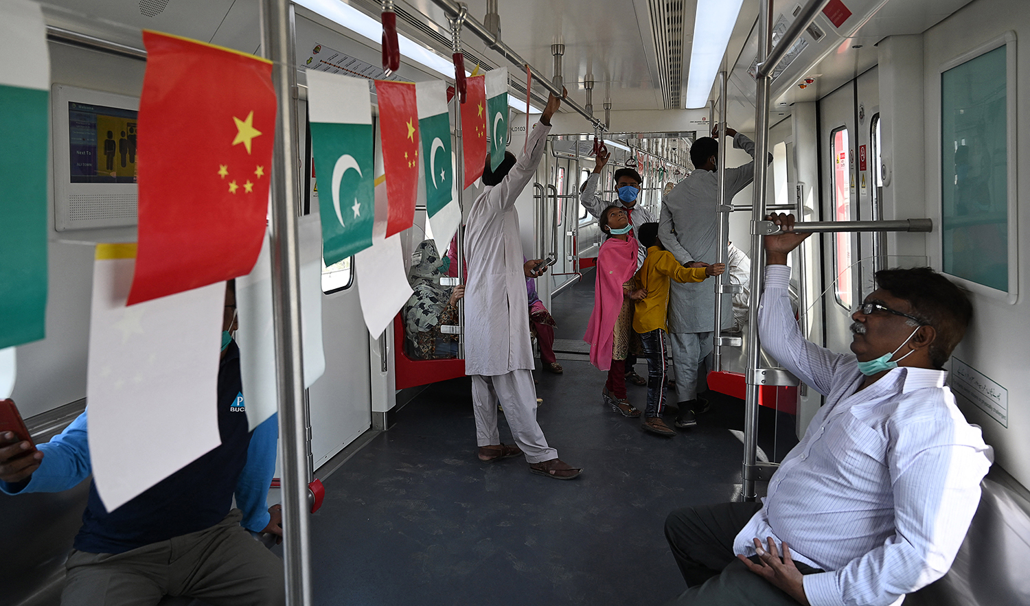 Passengers ride in a newly built Orange Line Metro Train (OLMT), a metro project planned under the China-Pakistan Economic Corridor (CPEC), a day after an official opening in the eastern city of Lahore on October 26, 2020. (AFP/File)