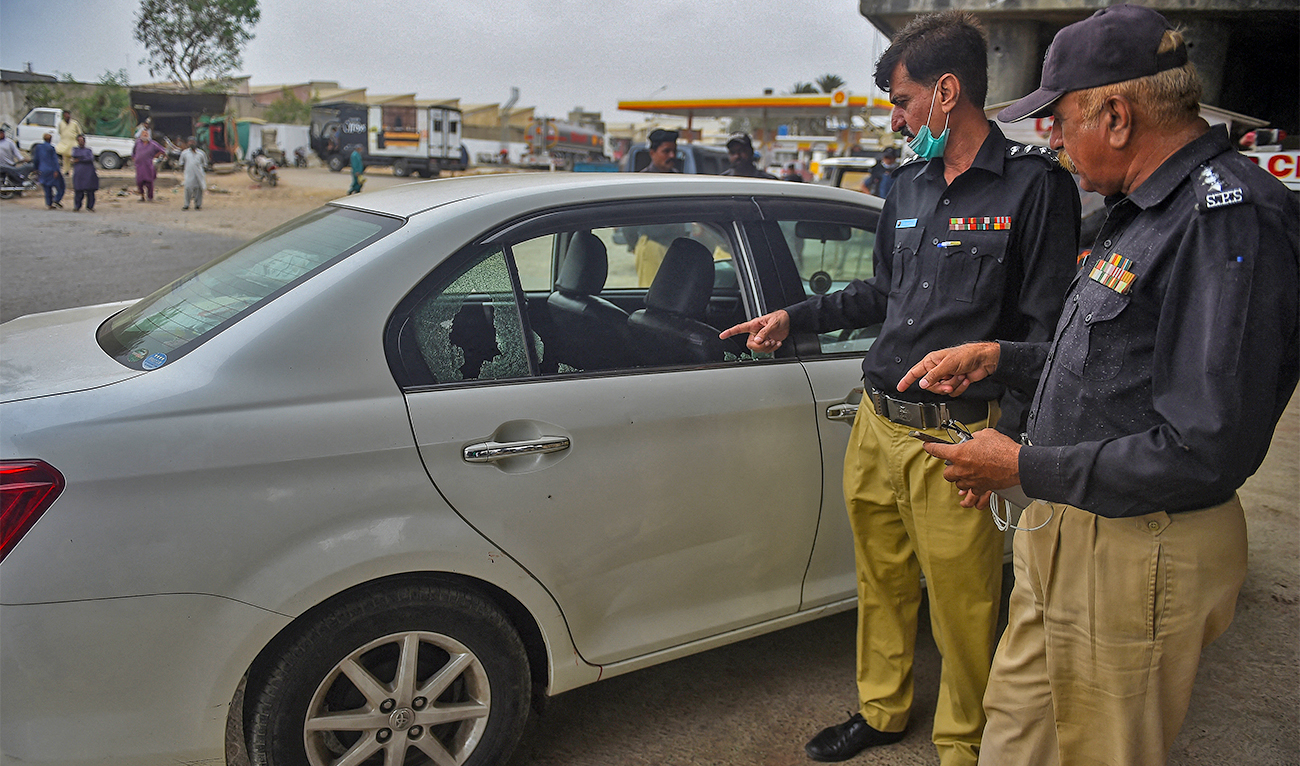 Security officials examine a vehicle in Pakistan’s port city of Karachi on July 28, 2021. (AFP/File)