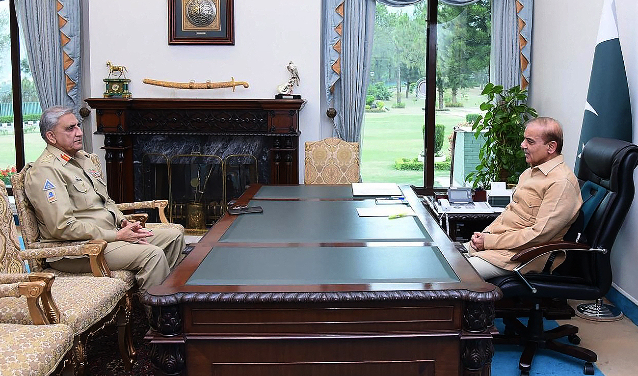 This handout photograph taken on April 19, 2022, and released by the Pakistan Prime Minister's Office shows Prime Minister Shehbaz Sharif (R) speaks with Army Chief General Qamar Javed Bajwa (L) at the Prime Minister House in Islamabad. (Photo courtesy: AFP/File)