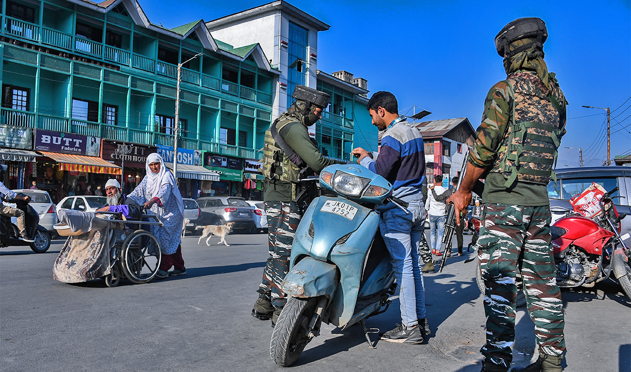 ecurity personnel search the bag of a motorist in a street in Srinagar on October 15, 2021, following the killing of two army personnel in an encounter with suspected militants in Poonch district, local media reported. (AFP/File)