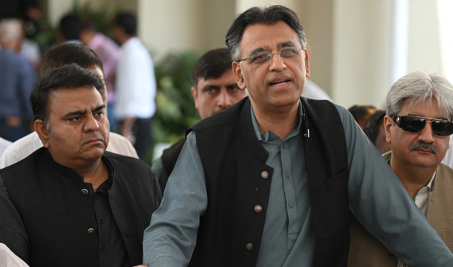 Laders of Pakistan Tehreek-e-Insaf (PTI) party of Prime Minister Imran Khan, Asad Umar (R) and Fawad Chaudhry (L) speak with the media outside the Supreme Court building prior to start a hearing, in Islamabad on April 6, 2022. (AFP/File)