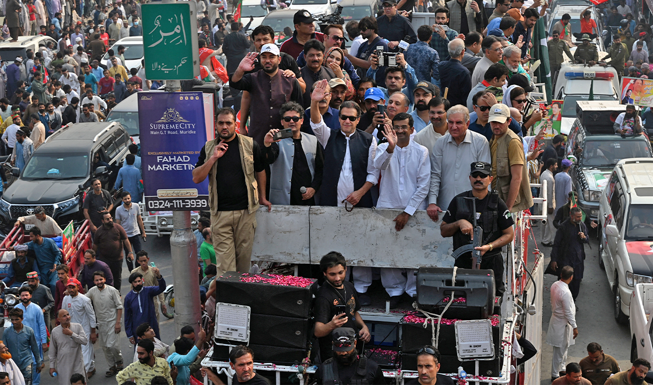 Pakistan's former prime minister Imran Khan (C) waves to his supporters during an anti-government march towards Islamabad city, demanding early elections, in Muridke district, about 29 km from Lahore, Pakistan, on October 30, 2022. (AFP/File)