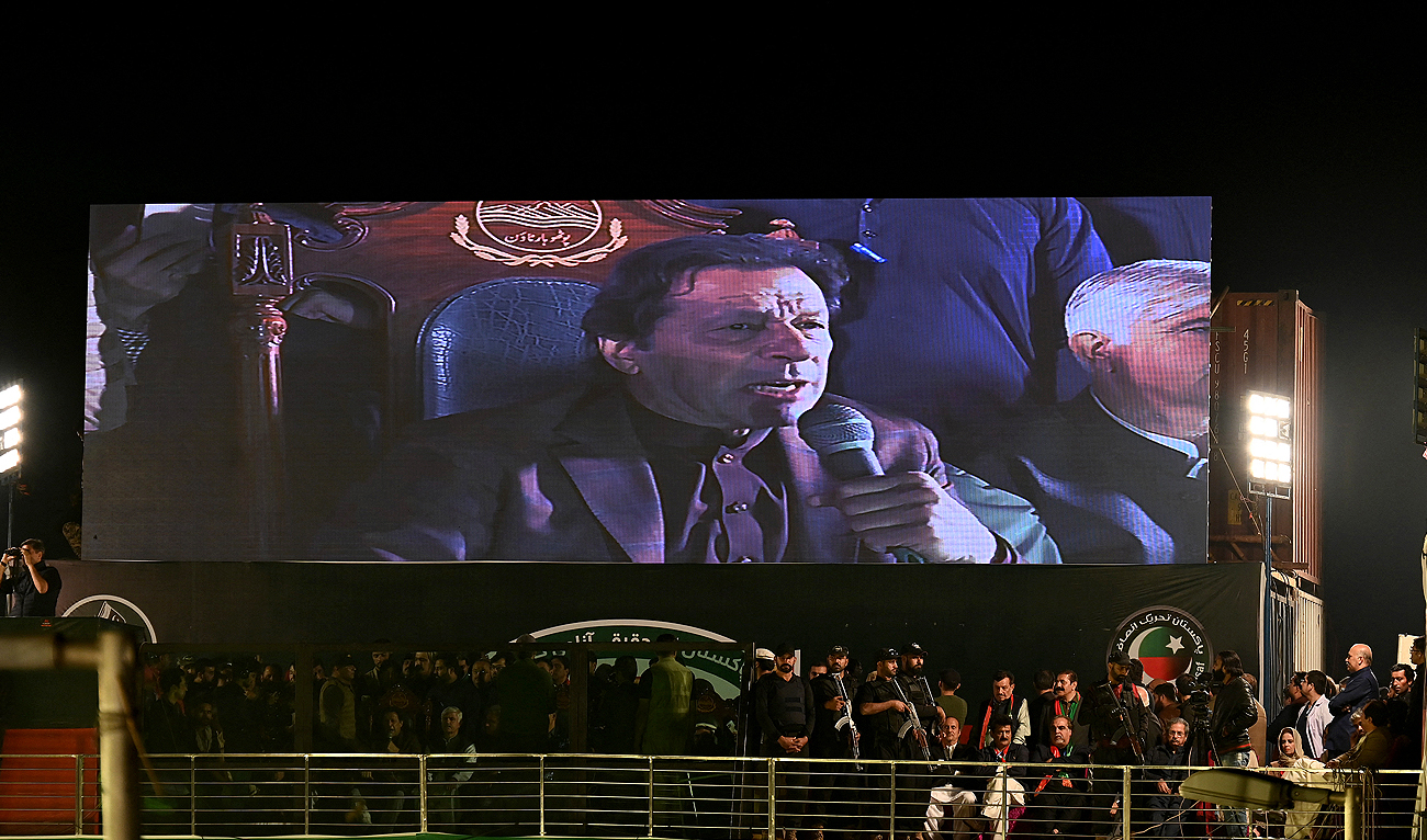 Former Pakistan's Prime Minister Imran Khan appears on a giant screen as he addresses an anti-government rally in Rawalpindi on November 26, 2022. (Photo courtesy: AFP)