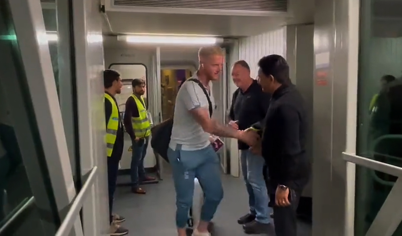 England's Ben Stokes shakes hands with a Pakistani official as his team arrives at Islamabad airport on November 27, 2022, for the Test series between Pakistan and England. (Photo courtesy: Twitter/TheRealPCB/Screengrab)