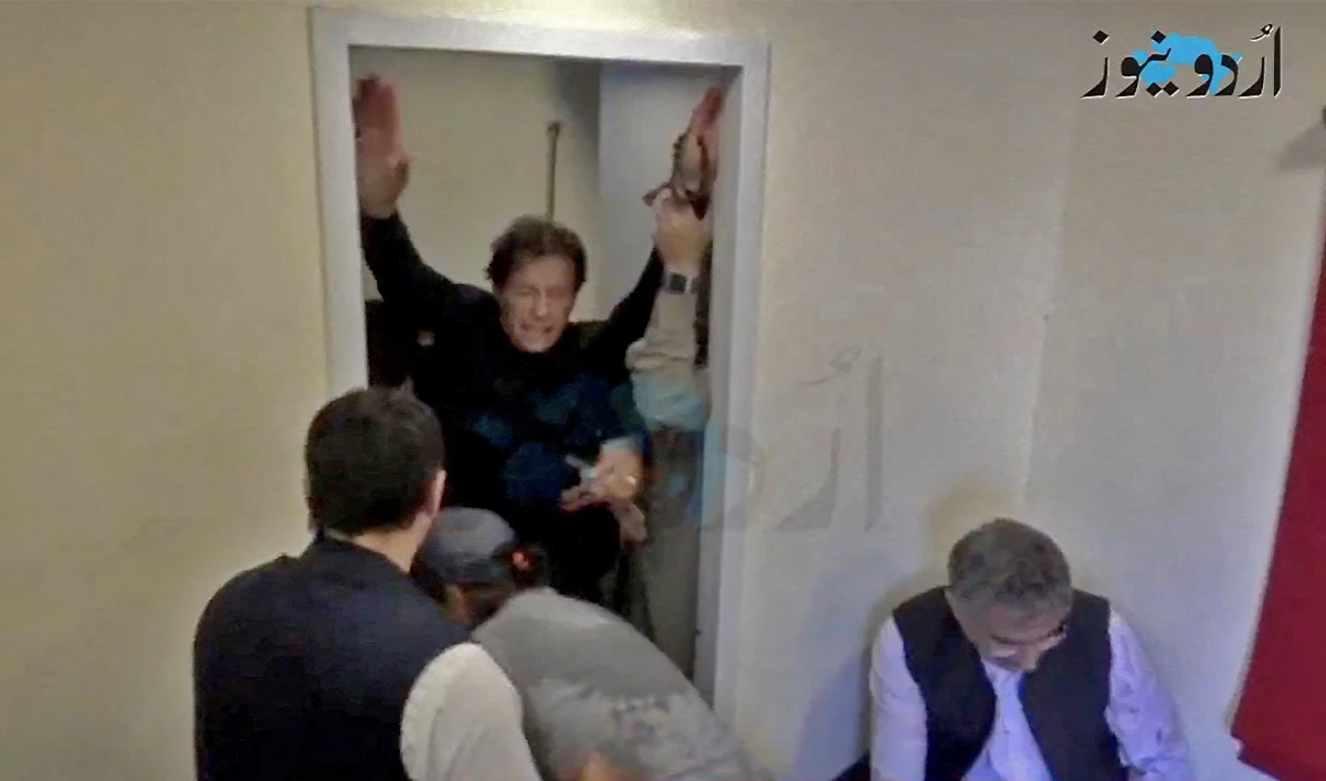 Former Pakistani Prime Minister Imran Khan is helped after he was shot in the shin in Wazirabad, Pakistan November 3, 2022 in this still image obtained from video. (Urdu News)