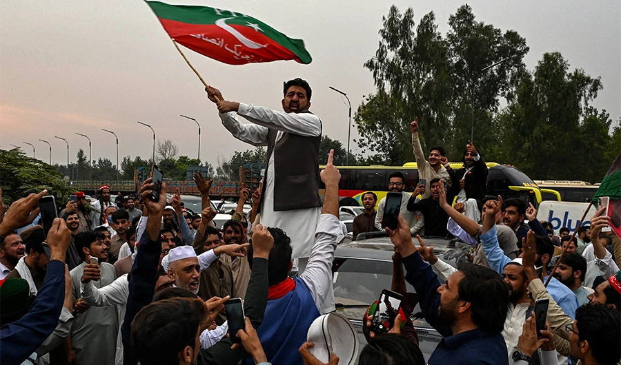 Supporters of former Pakistani prime minister Imran Khan, take part in a protest as they block the main road a day after the assassination attempt on Khan,in Peshawar on November 4, 2022. (AFP)