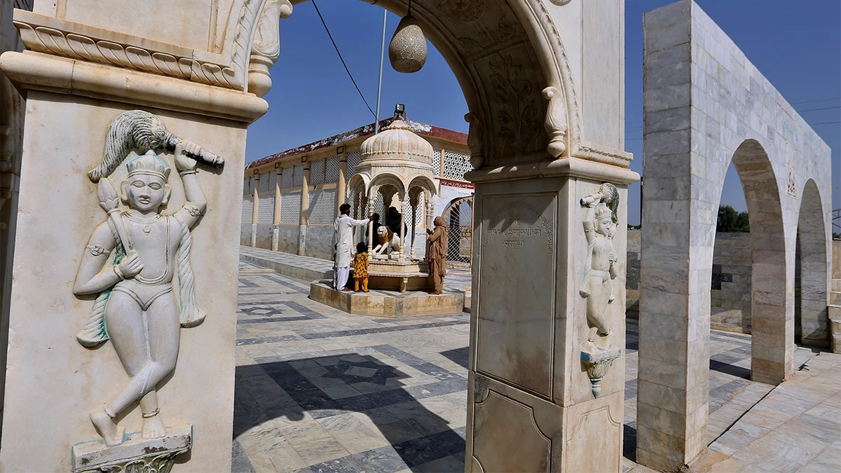 A family from Pakistani Hindu community visit at the Sadhu Bela temple, located in an island on the Indus River, in Sukkur, Pakistan, on October 26, 2022. (AP)