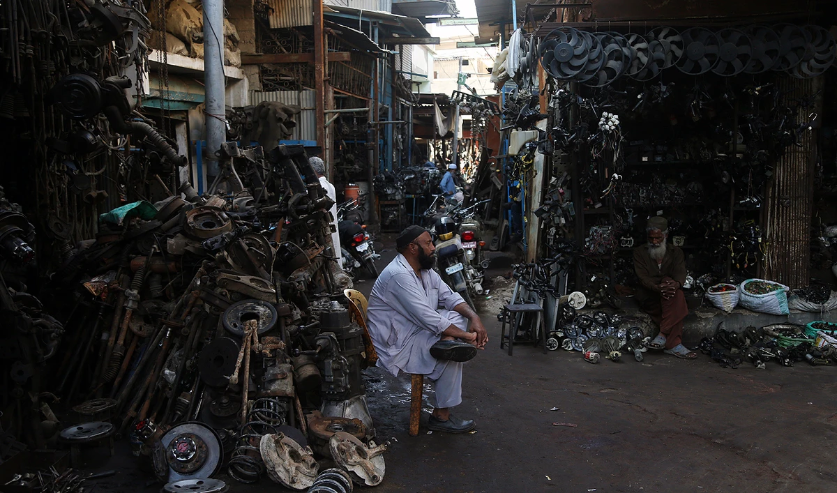 An elderly trader waits for customers at the Sher Shah Bazar in Karachi, Pakistan, on November 01, 2022. This is the largest scrap market in Pakistan (AN Photo by S.A. Babar)