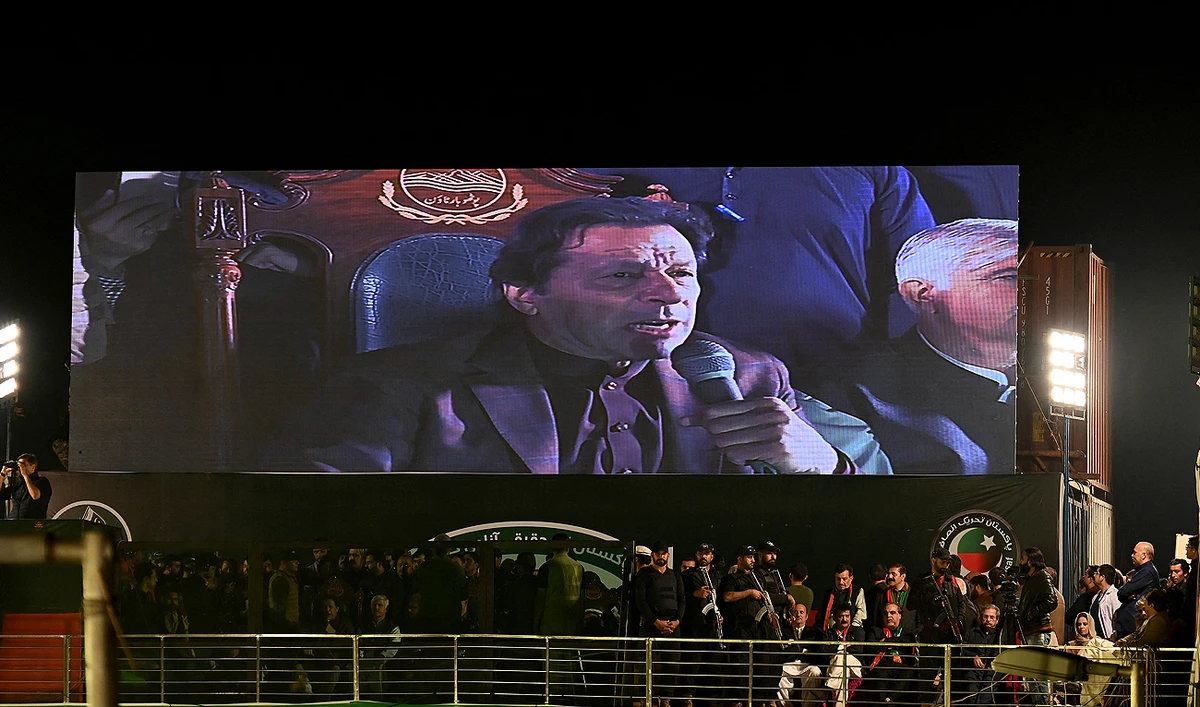 Former Pakistan's Prime Minister Imran Khan appears on a giant screen as he addresses an anti-government rally in Rawalpindi on November 26, 2022. (Photo courtesy: AFP)