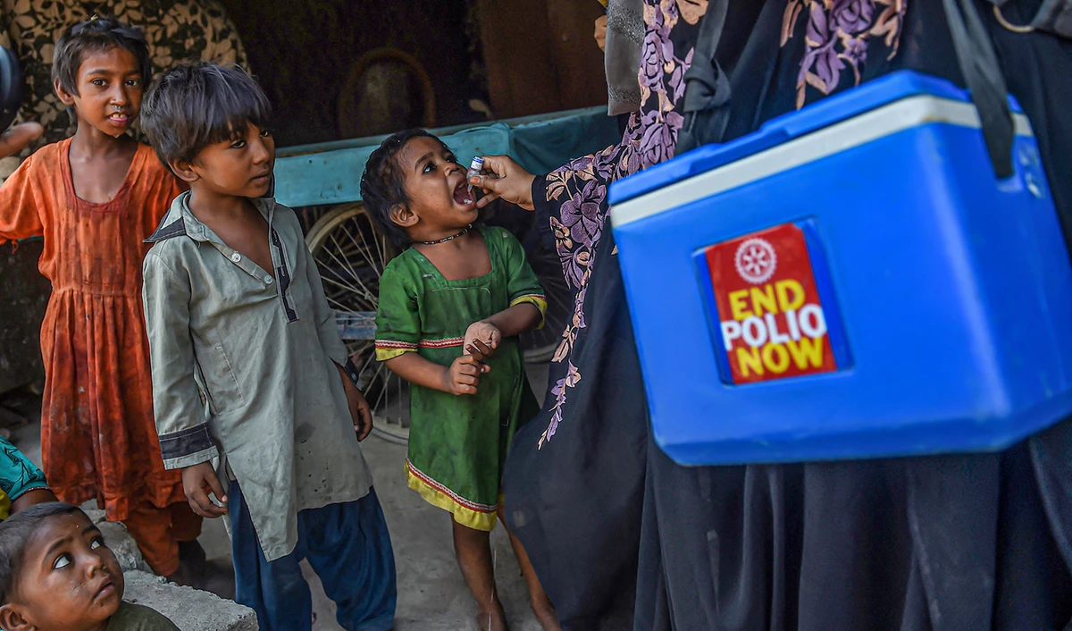 A health worker administers polio vaccine drops to a child during a vaccination campaign in Karachi, Pakistan, on October 24, 2022. (AFP/File)