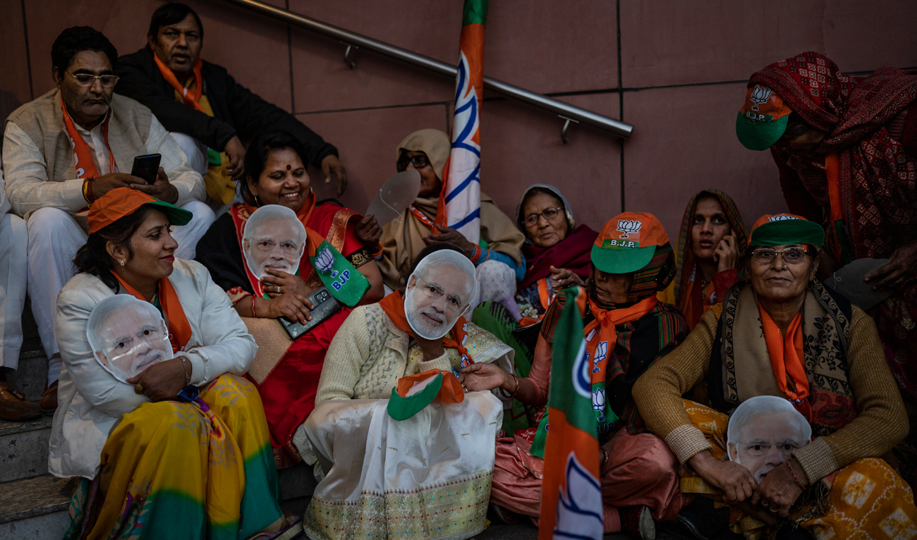 Supporters wear masks of Indian Prime Minister Narendra Modi at the Bharatiya Janata Party (BJP) headquarters in New Delhi, India, Thursday, Dec. 8, 2022. (Photo courtesy: AFP)