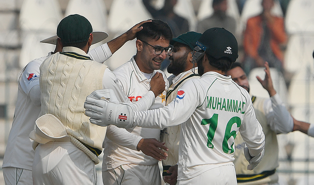 Pakistan's Abrar Ahmed (C) celebrates with teammates after taking the wicket of England's Harry Brook (not pictured) during the first day of the second cricket Test match between Pakistan and England at the Multan Cricket Stadium in Multan on December 9, 2022. (Photo courtesy: AFP)