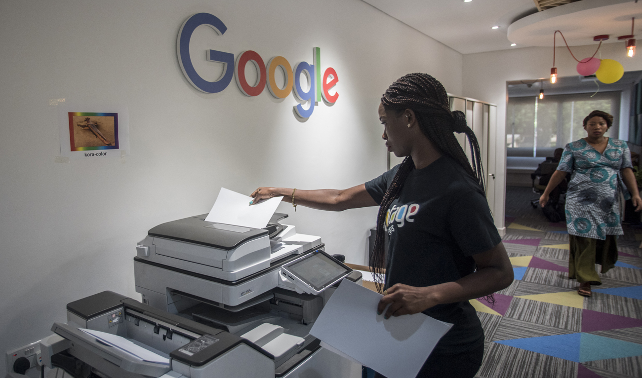 A woman makes copies at the Google Artificial Intelligence (AI) office in Accra on April 10, 2019. (Photo courtesy: AFP/File)