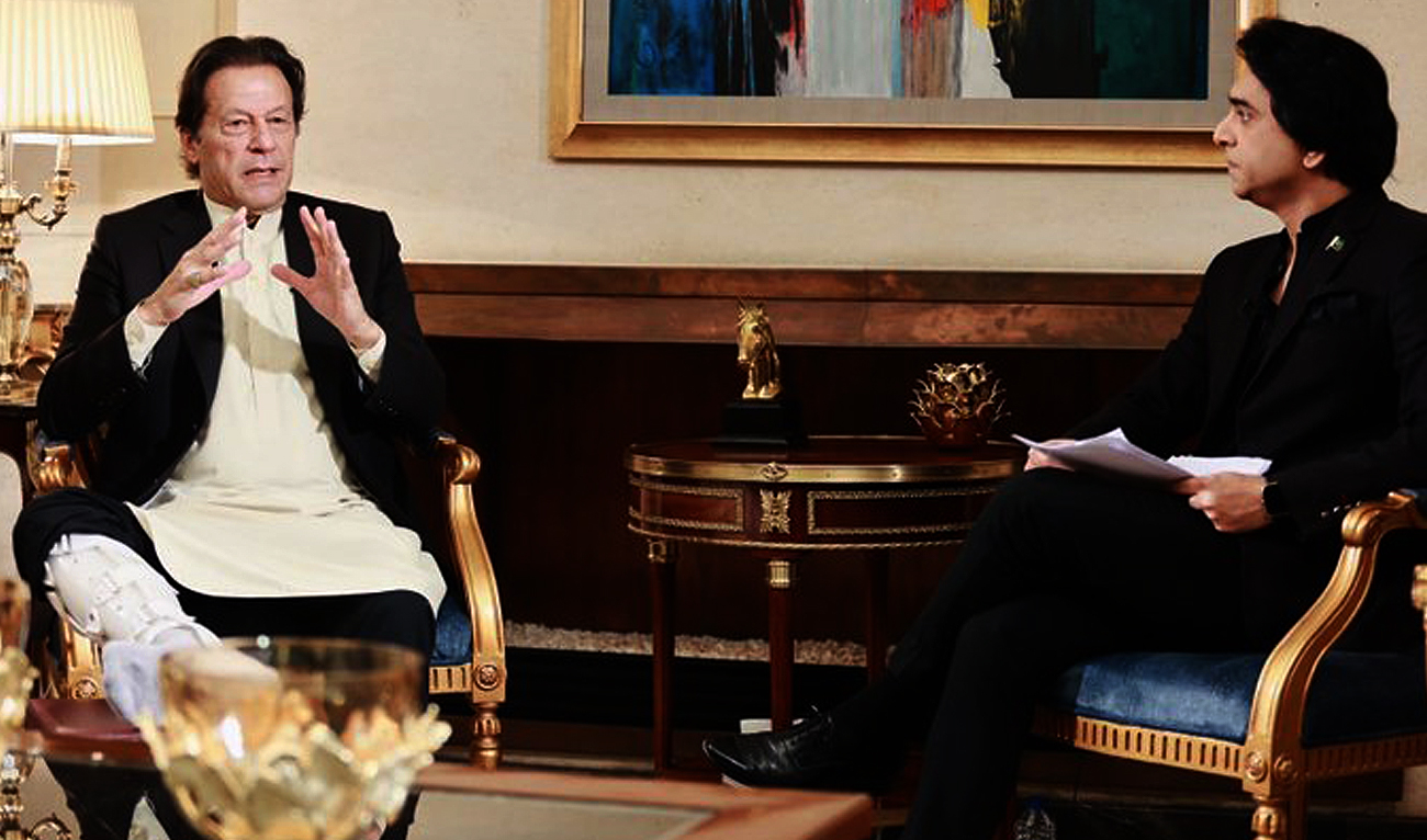 Pakistan's former prime minister Imran Khan (left) gestures during an interview with journalist Jameel Farooqui (right) for a private TV channel in Lahore, broadcasted on December 10, 2022. (Photo courtesy: Twitter/FarooquiJameel)