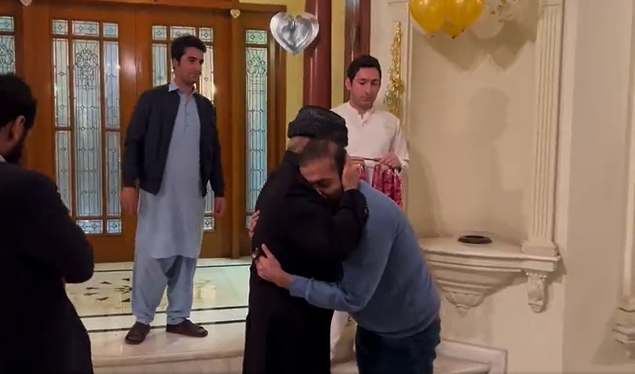 This screengrab, taken on December 11, 2022, shows Pakistan's prime minister Shehbaz Sharif receiving his son Suleman Sharif, who left the country following corruption cases in 2018, at his personal residence in Lahore on December 10, 2022. (Courtesy: Twitter/pmln_org)