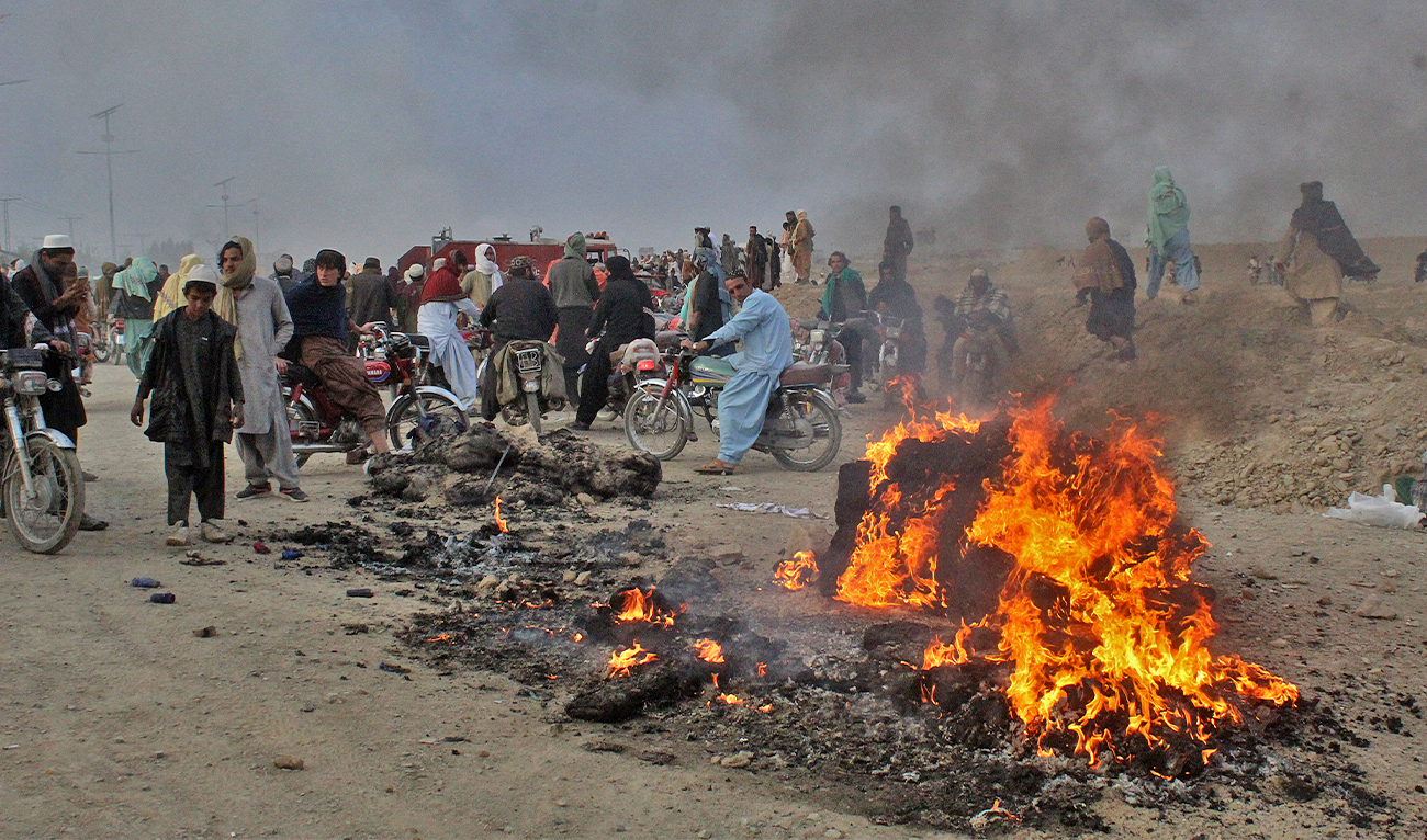 Residents gather after Taliban forces fired mortars at Pakistan's border town of Chaman on December 11, 2022. (AFP)