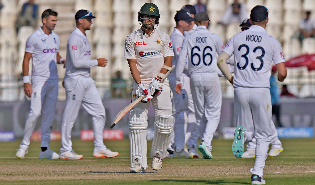 Pakistan's Abrar Ahmed, center, walks off the field after his dismissal during the fourth day of the second test cricket match between Pakistan and England, in Multan, Pakistan, on December 12, 2022. (AP)