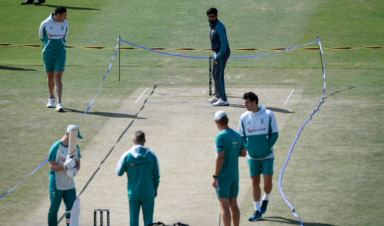 In the picture taken on March 7, 2022, Pakistan's captain Babar Azam (top C) inspects the pitch along with Australia's players at the Rawalpindi Cricket Stadium in Rawalpindi. (Photo courtesy: AFP/File)