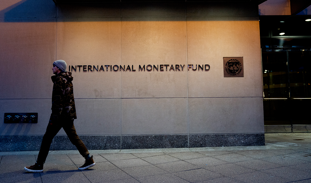 A pedestrian walks past the International Monetary Fund (IMF) headquarters in Washington, DC on January 10, 2022. (Photo courtesy: AFP/File)