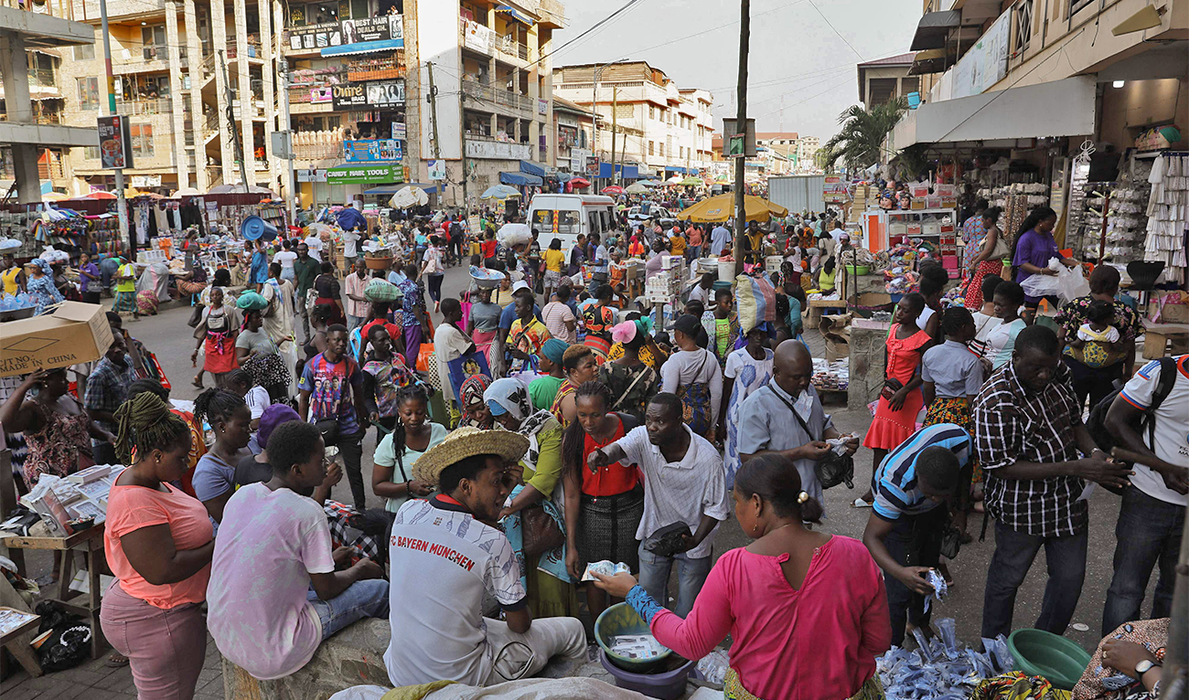 People shop at the Makola Market in Accra, Ghana, on December 1, 2022. (AFP)