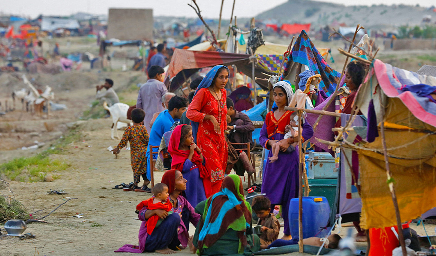 Women and children, who become displaced, take refuge in a camp, following rains and floods during the monsoon season in Sehwan, Pakistan on September 14, 2022. (REUTERS)