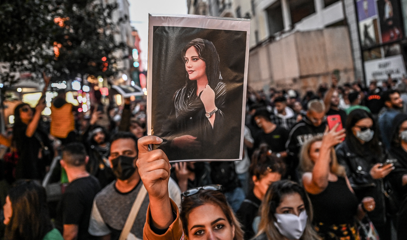 In this file photo taken on September 20, 2022, on Istiklal avenue in Istanbul a protester holds a portrait of Mahsa Amini during a demonstration in support of Amini, a young Iranian woman who died after being arrested in Tehran by the Islamic Republic's morality police. (Photo courtesy: AFP/File)