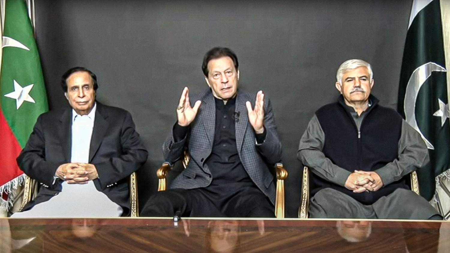 Former Pakistan Prime Minister Imran Khan, center, along with Punjab Chief Minister Pervaiz Elahi, left, and Khyber Pakhtunkhwa Chief Minister Mahmood Khan addresses his supporters in Lahore through video link on December 17, 2022. (Photo courtesy: Pakistan Tehreek-e-Insaf)