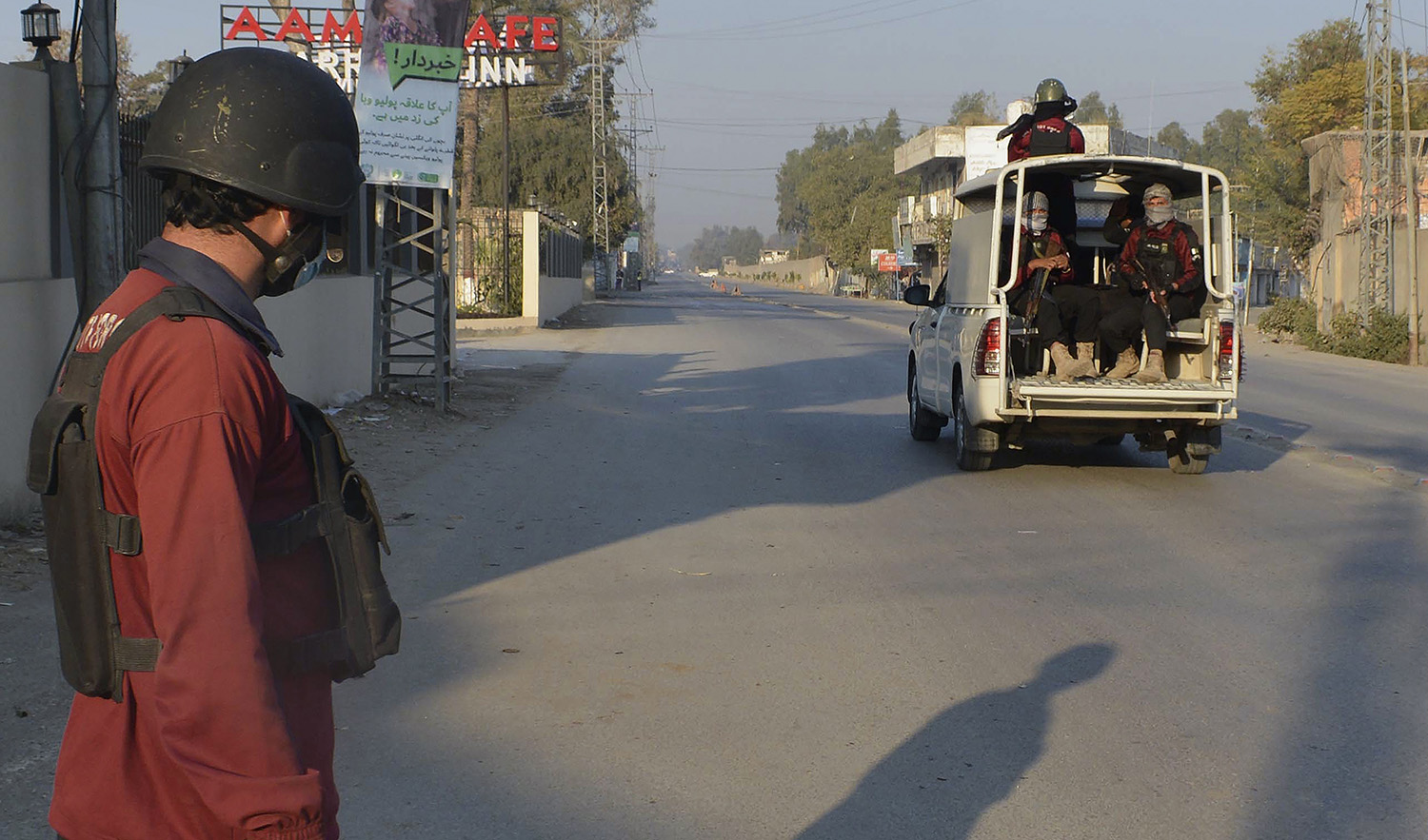 Security officials patrol on a blocked road leading to a counter-terrorism center, where several Pakistani Taliban detainees have taken police and others hostage inside the compound, in Bannu district of Pakistan's Khyber Pakhtunkhwa province on December 19, 2022. (AP)