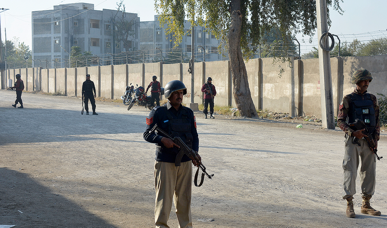 Security officials guard a blocked road leading to a counter-terrorism center after security forces starting to clear the compound seized earlier by Pakistani Taliban militants in Bannu, a northern district in the Pakistan's Khyber Pakhtunkhwa province, Tuesday, Dec. 20, 2022. (Photo courtesy: AP)