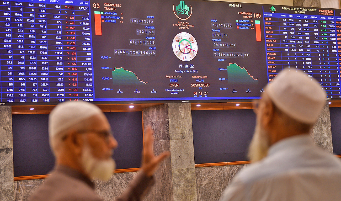 Stockbrokers speak while monitoring the share prices during a trading session at the Pakistan Stock Exchange (PSX) in Karachi on July 19, 2022. (AFP/File)