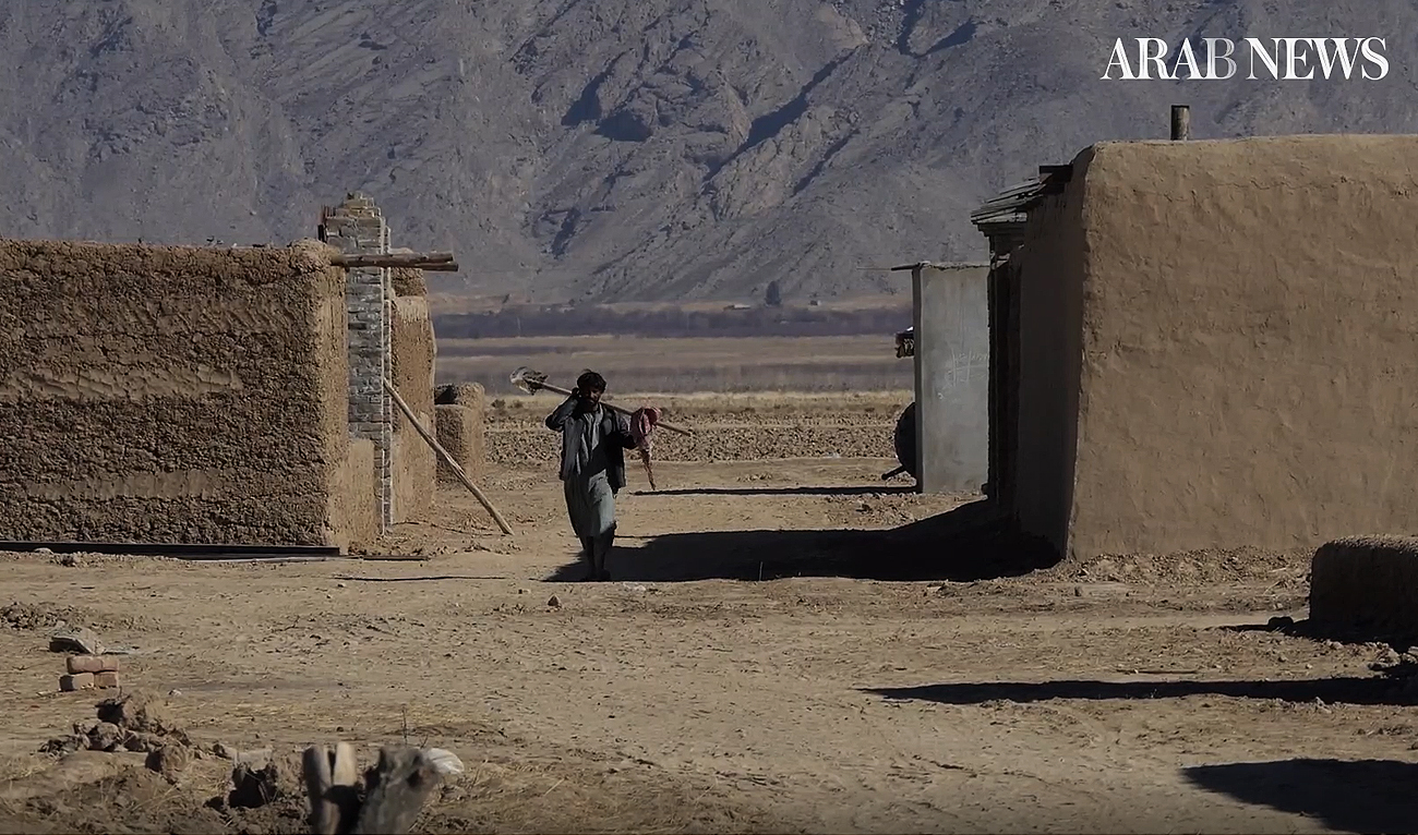 A construction worker walks past house structures in Dasht, Balochistan, on December 15, 2022. (AN Photo)