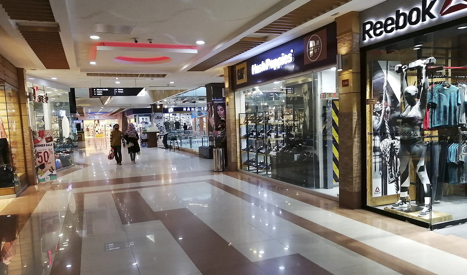 Residents walk through an empty area of a mall in Islamabad, Pakistan, on March 15, 2020. (AFP/File)