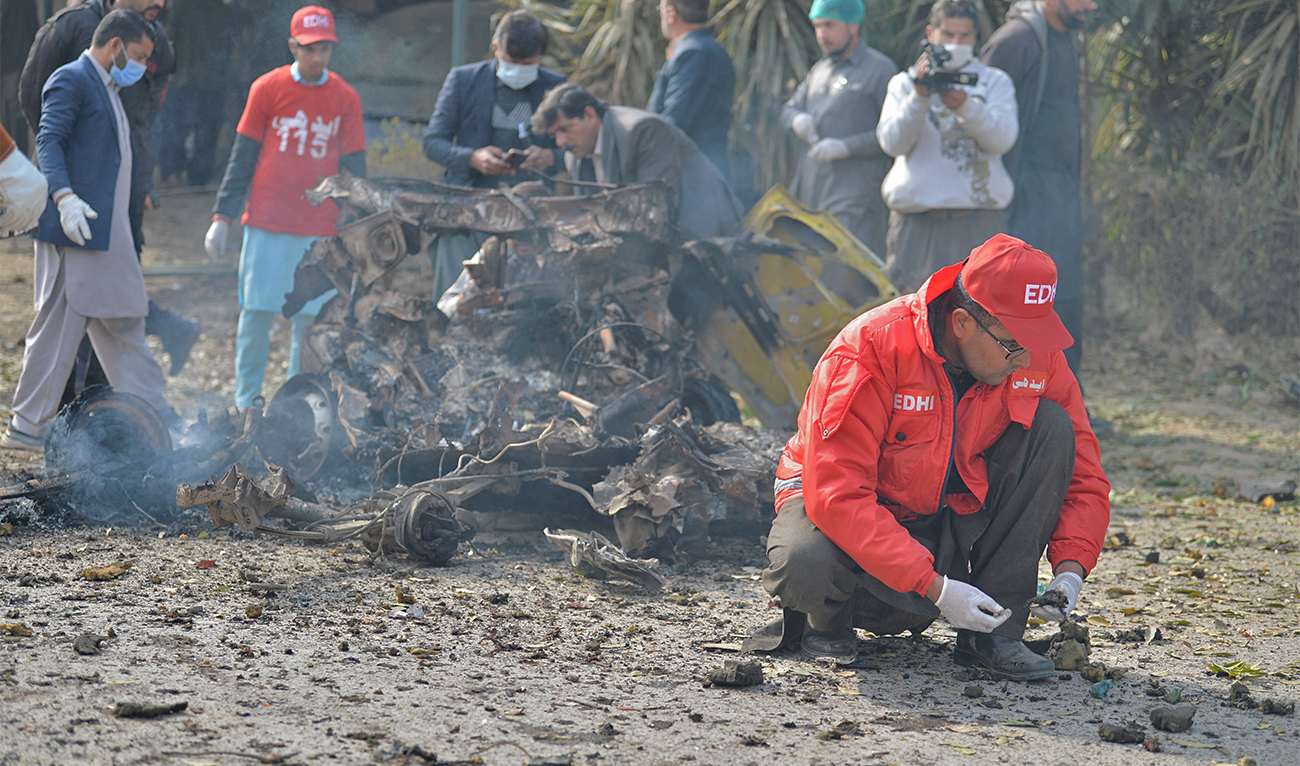 Policemen collect evidence at the suicide blast site in Islamabad on December 23, 2022. (AFP)
