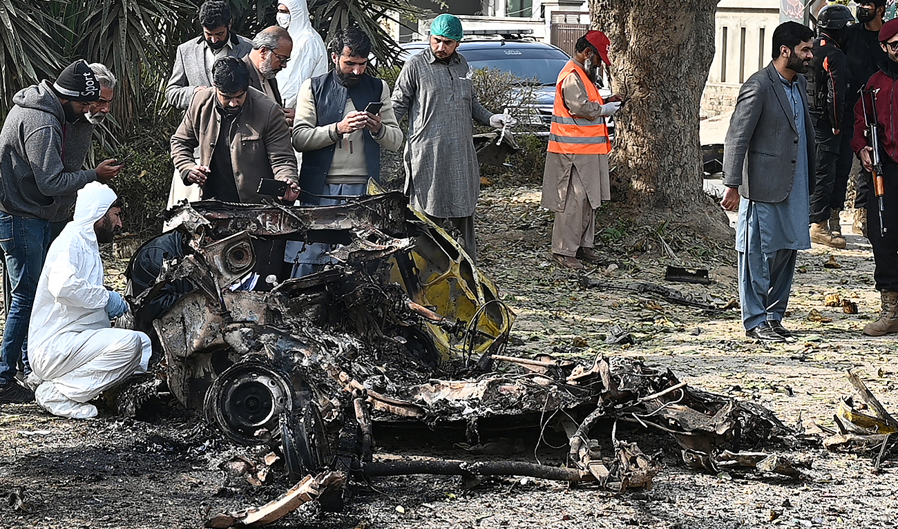 Policemen collect evidence at the suicide blast site in Islamabad on December 23, 2022. (Photo courtesy: AFP)