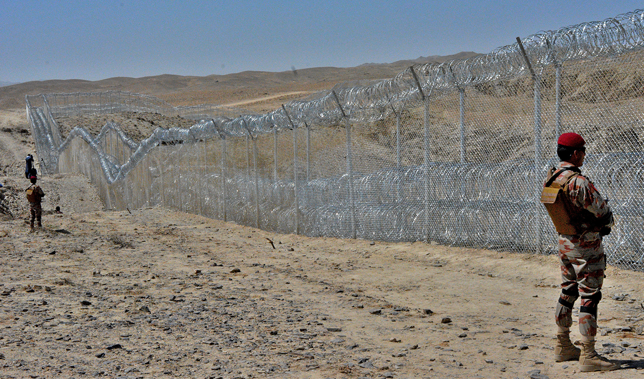 A Pakistani army soldier stands guard along with border fence at the Pak-Afghan border near the Punjpai area in Pakistan's Balochistan province on May 8, 2018. (AFP/File)