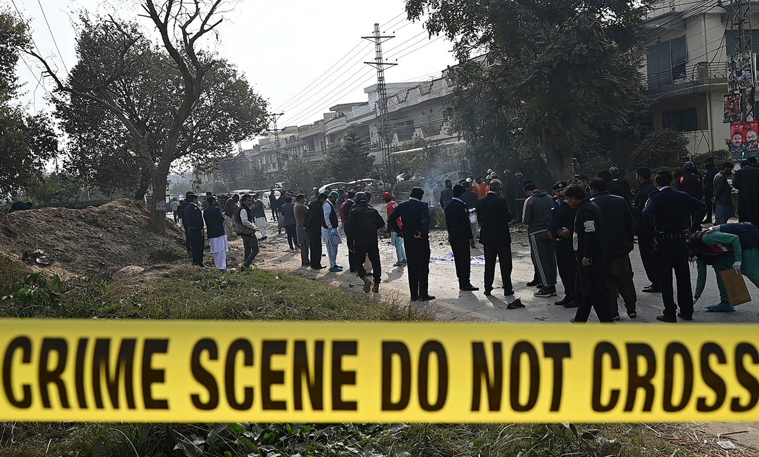 Policemen gather at the suicide blast site in Islamabad on December 23, 2022. (AFP)