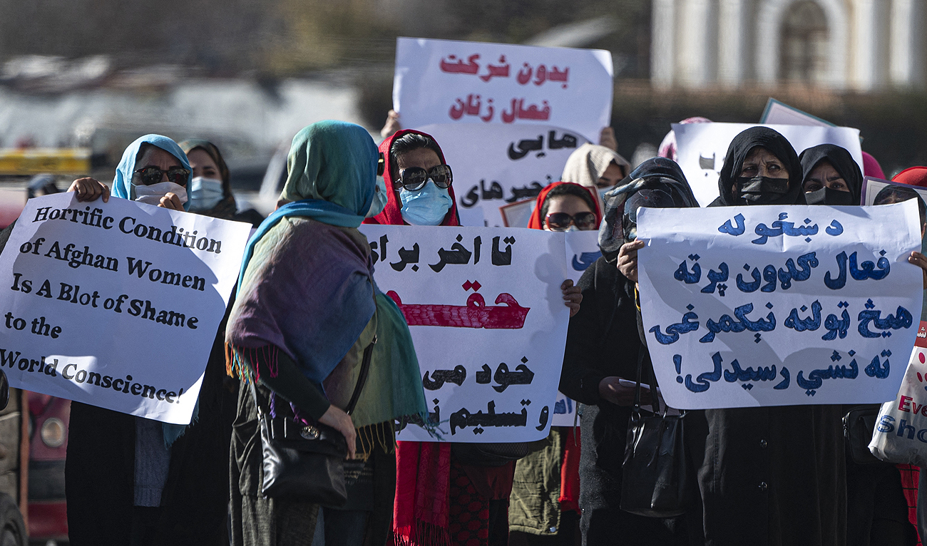 Women hold placards during a protest calling for their rights to be recognised, near the Shah-e-Do Shamshira mosque in Kabul on November 24, 2022. (Photo courtesy: AFP)