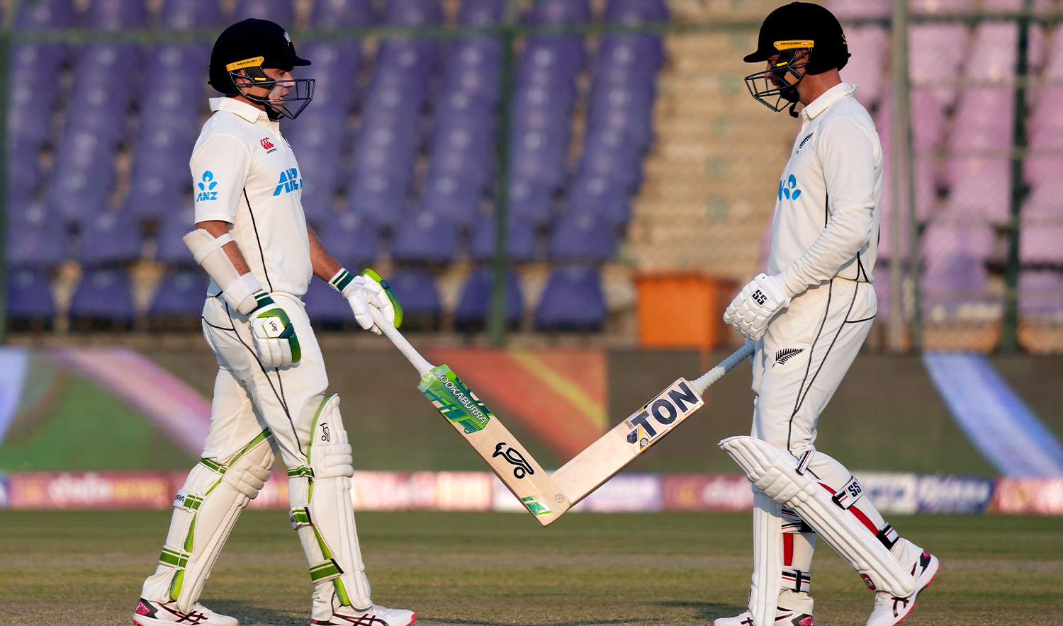 New Zealand's Tom Latham, left, celebrates with teammate Devon Conway after hitting a boundary during the second day of first test cricket match between Pakistan and New Zealand, in Karachi, Pakistan, on December 27, 2022. (AP)