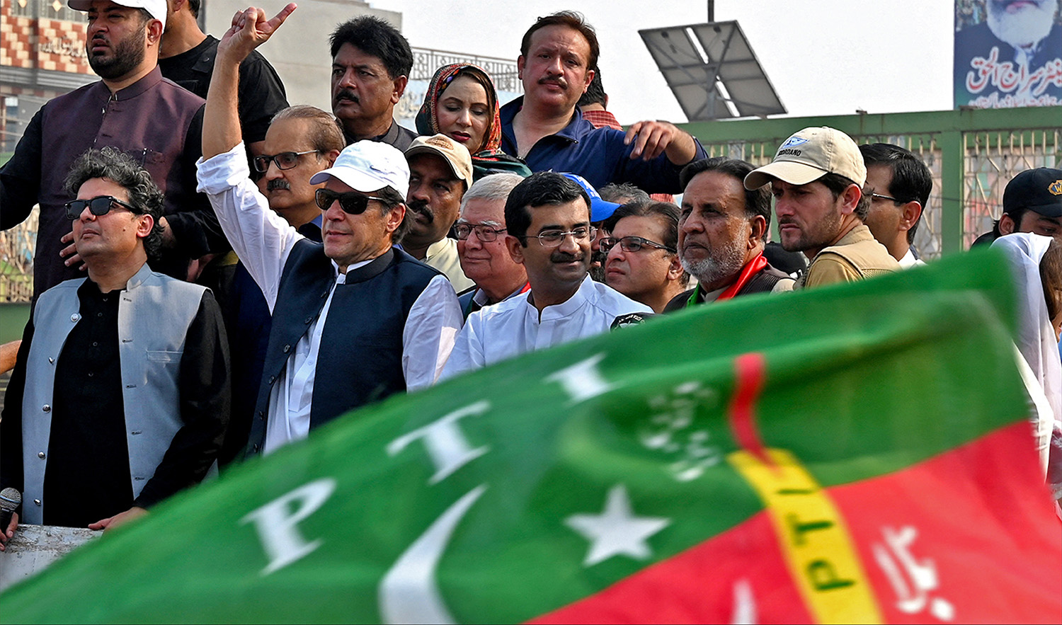 Pakistan's former prime minister Imran Khan (4L) gestures to his supporters during an anti-government march towards Islamabad city, demanding early elections, in Muridke district, about 29 km from Lahore on October 30, 2022. (AFP/File)