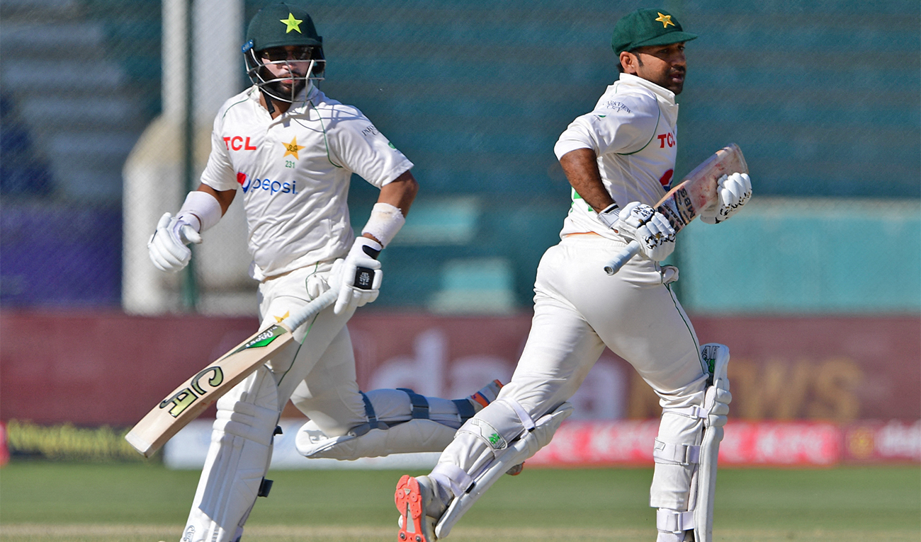 Pakistan's Sarfaraz Ahmed (R) and Imam-UL-Haq (L) run between the wickets during the fifth and final day of the first Test match between Pakistan and New Zealand at the National Stadium in Karachi on December 30, 2022. (AFP)