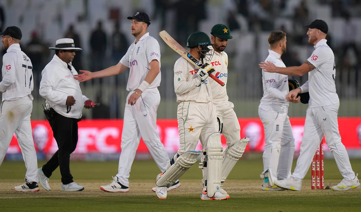 Pakistan's Zahid Mahmood, center, Salman Ali, third right, walk off the field as England's players shake hands on the end of the third day play of the first test cricket match between Pakistan and England, in Rawalpindi, Pakistan, on December 3, 2022. (AP)