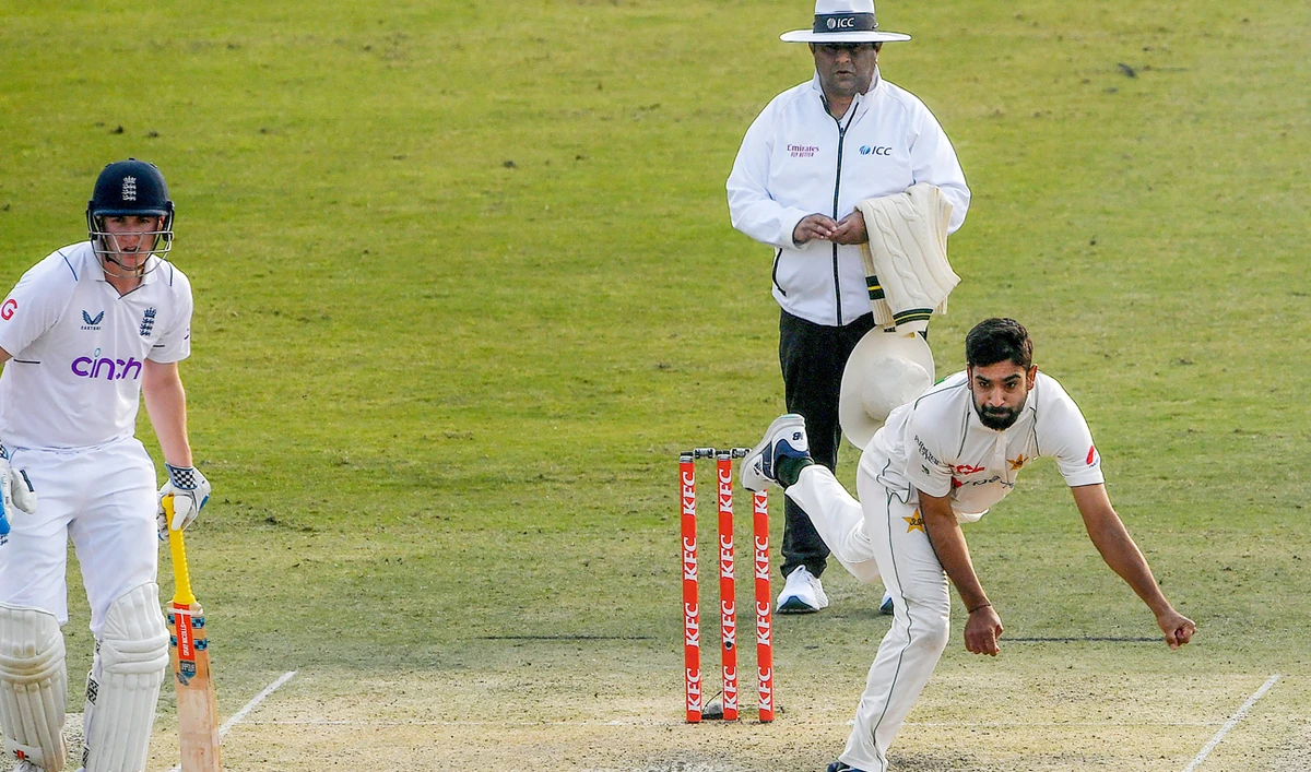 Pakistan's Haris Rauf (R) delivers the ball England's Harry Brook (L) watches during the first day of the first cricket Test match between Pakistan and England at the Rawalpindi Cricket Stadium, in Rawalpindi on December 1, 2022. (Photo courtesy: AFP)