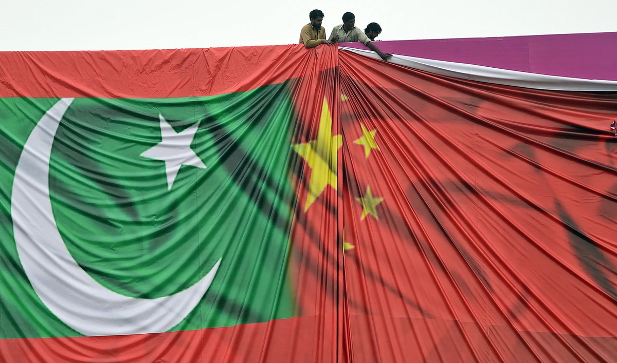 Pakistani labourers arrange a welcome billboard featuring the Chinese and Pakistani national flags ahead of the forthcoming visit by Chinese President Xi Jinping in Islamabad, Pakistan, on April 18, 2015. (Photo courtesy: AFP/File)