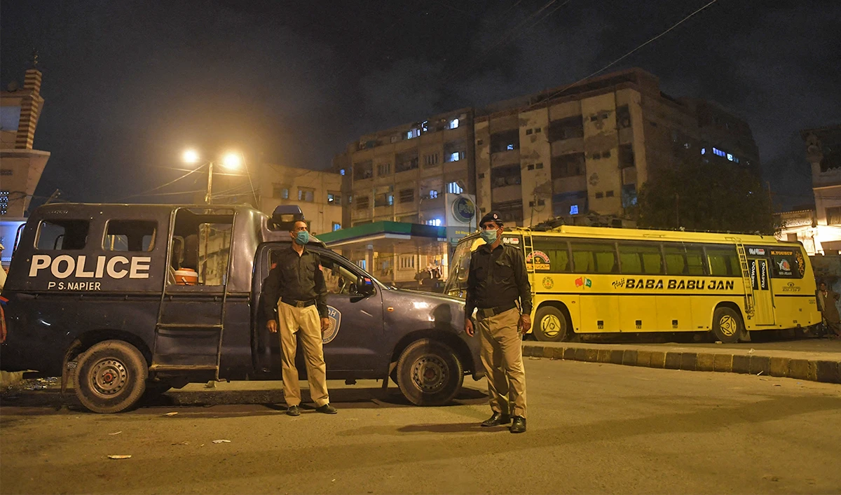 Police officers stand guard on a street at a residential area in Karachi, Pakistan, on June 18, 2020. (AFP/File)