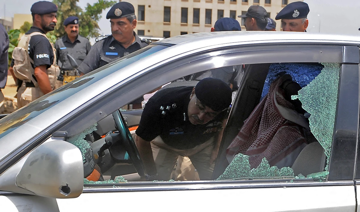 Pakistani police officials inspect the bullet-riddled vehicle of a Saudi diplomat after a deadly attack in Karachi on May 16, 2011. (AFP)