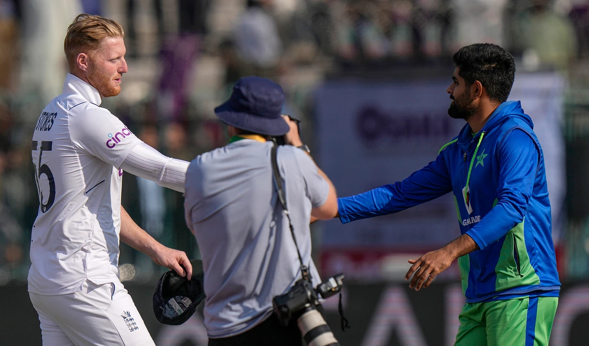 England's skipper Ben Stokes, left, shakes hand with his Pakistani counterpart Babar Azam after winning the second test cricket match against Pakistan, in Multan, Pakistan, on December 12, 2022. (AP)