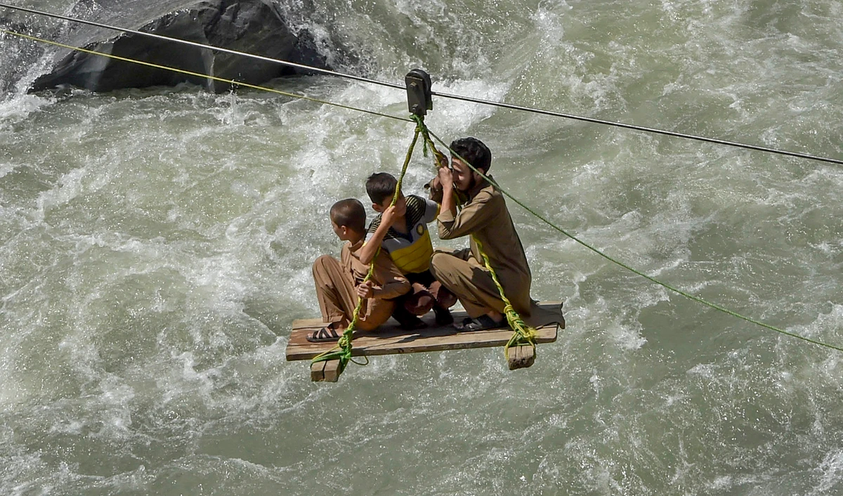 Local residents use a temporary cradle service to cross the river Swat after heavy rains in Bahrain town of Swat valley in Khyber Pakhtunkhwa province on August 31, 2022. (AFP/File)